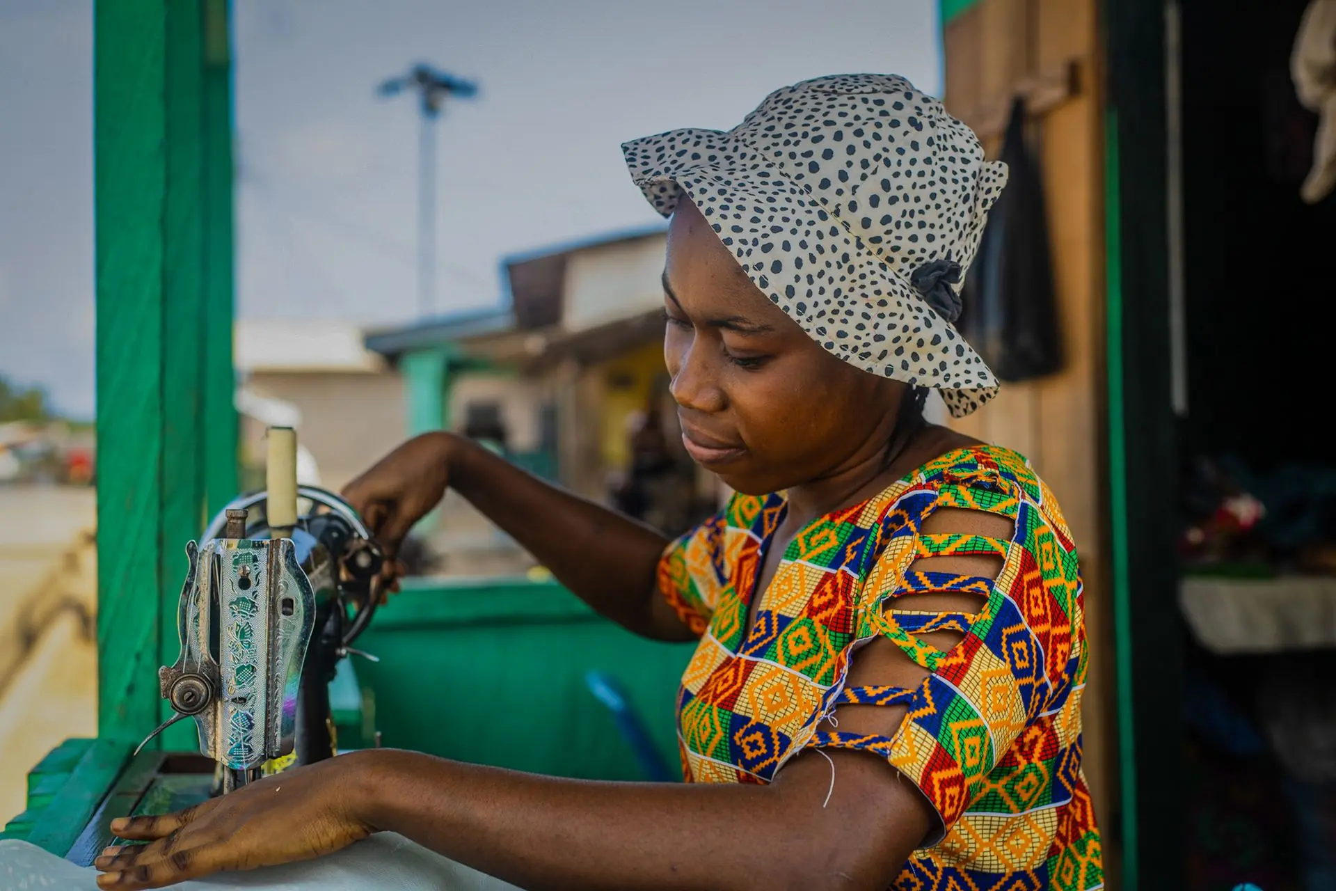 Ghanaian seamstress working at her sewing machine in Takoradi, Ghana
